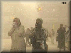 New York City residents run through the dust from the collapse of the World Trade Center